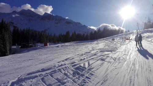 a person is skiing down a snow covered slope at Bella Vista in Sörenberg