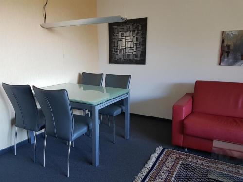 a room with a table and chairs and a couch at Gemütliche Ferienwohnung Im Disentiserhof in Disentis
