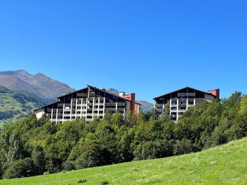 two buildings sitting on top of a hill at Gemütliche Ferienwohnung Im Disentiserhof in Disentis