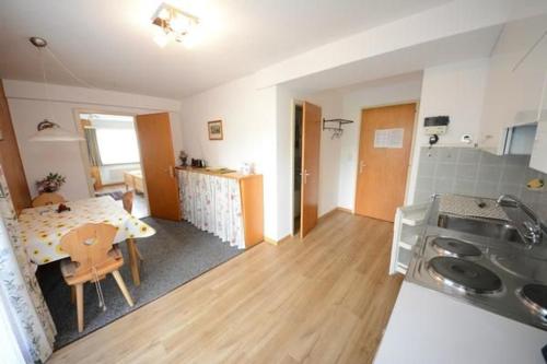 a kitchen and a dining room with a table and a kitchen at Chesa Talvo in Samedan