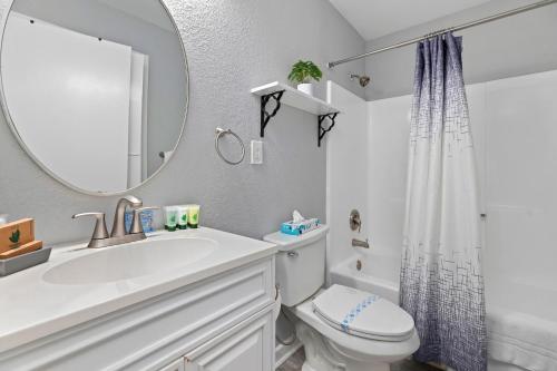 a white bathroom with a sink and a mirror at Gum Tree 4 with Wintergreen Advantage in Wintergreen