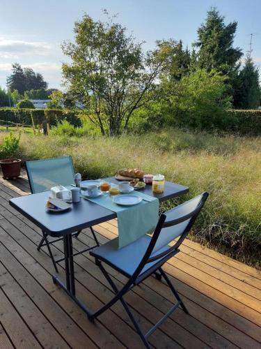 a blue table and chairs sitting on a deck at Gartenbungalow 2 3 Personen in Arbon