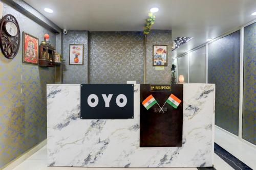 a exhibit with a ovy sign on a marble counter at Hotel O Shivoham in Indirapuram