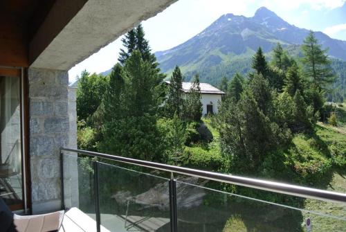 a balcony with a view of a mountain at La Montanella 4 in Maloja