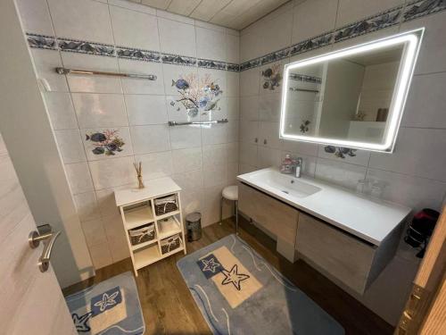 a bathroom with a sink and a mirror at Ferienwohnung Hälmli in Heiden