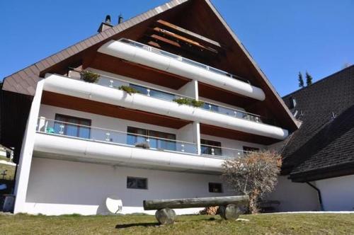 a large white building with a brown roof at Chäserruggblick in Unterwasser