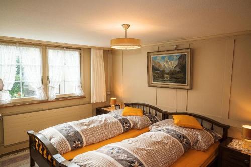 a group of three beds in a room at Ferienhaus Wühre in Appenzell