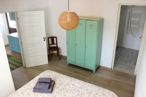 a room with green cabinets and a mirror at Vivenda Montanha - Relax in Nature in Alcaria
