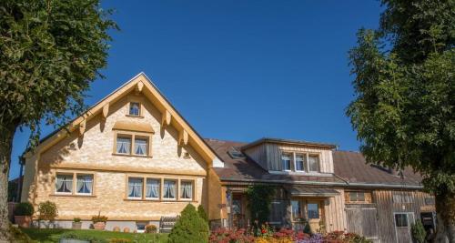 a large brick house with a roof at Bauernhof Fendrig Neue Wohnung in Haslen