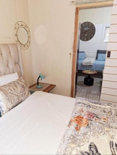 a bedroom with a bed and a living room at Richmond Hill Guest House in Port Elizabeth