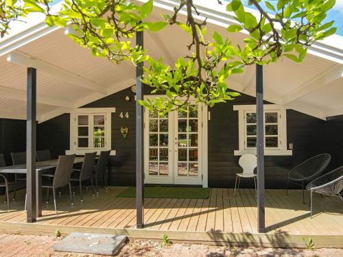 a porch with chairs and a table on a deck at 6 person holiday home in Fårvang in Fårvang