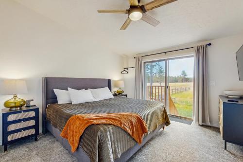 a bedroom with a bed and a large window at Meadowpine Retreat in Donnelly