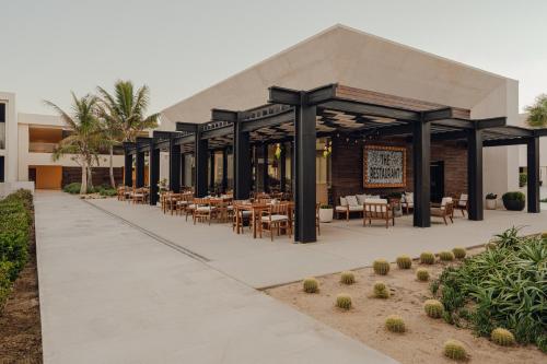 a restaurant with tables and chairs outside of a building at Nobu Hotel Los Cabos in Cabo San Lucas