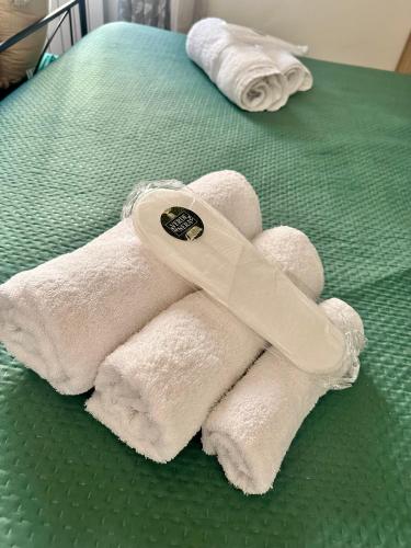 a pile of towels sitting on top of a bed at VerdeNera in Terni