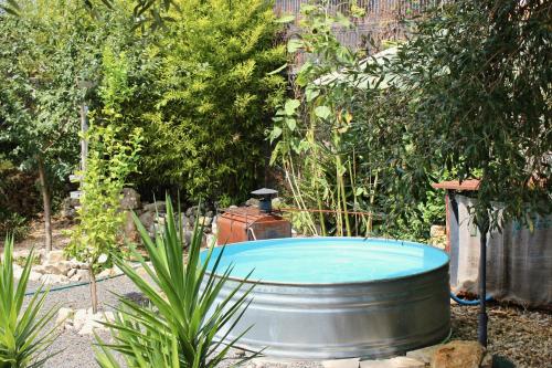 a hot tub in the middle of a garden at Vivenda Montanha - Relax in Nature in Alcaria