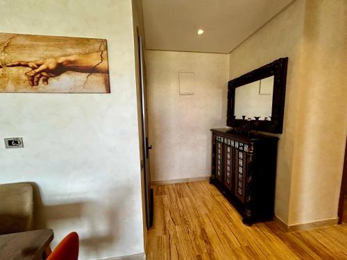 a living room with a television and a painting on the wall at Ocean side - Prestige & Douceur familliale in Casablanca
