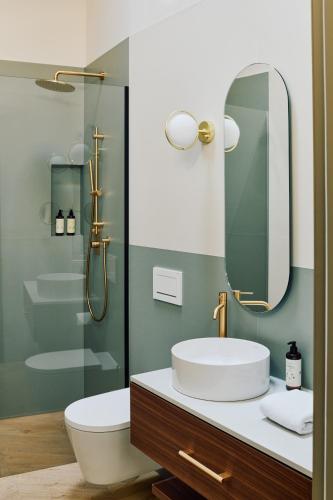 a bathroom with a sink and a mirror at Vista Lakefront Boutique Hotel in Ascona