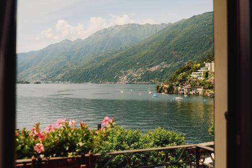 a view of a body of water with mountains at Vista Lakefront Boutique Hotel in Ascona