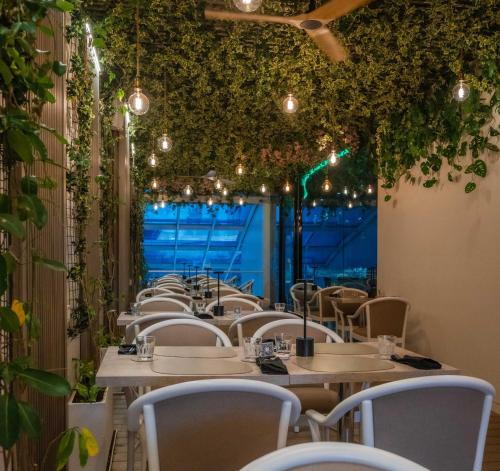 a row of tables and chairs in a restaurant at Holiday Inn Rosario by IHG in Rosario