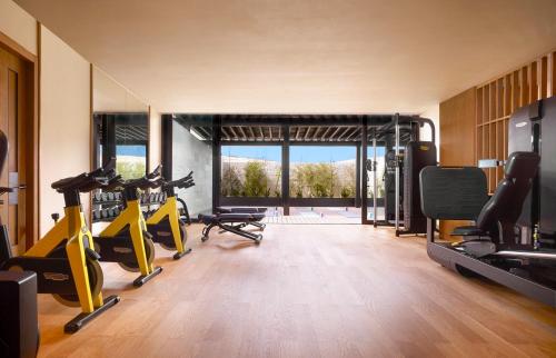 a gym with treadmills and exercise bikes in a room at Nobu Hotel Los Cabos in Cabo San Lucas