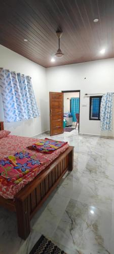 a bedroom with a large bed in a room at Shalom Homestay and Boating in Honāvar