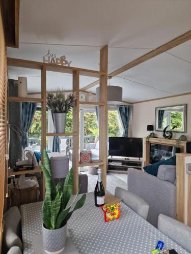 a living room with a couch and a table at Hawthorn Lodge in Saint Helens
