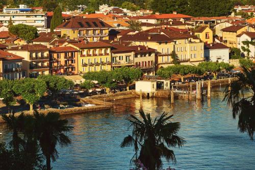 a town next to a body of water with buildings at Vista Lakefront Boutique Hotel in Ascona