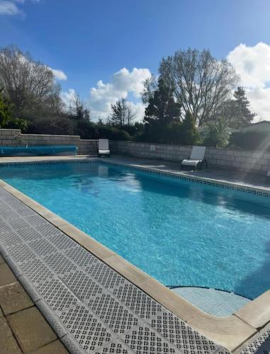 a large swimming pool with blue water at Hawthorn Lodge in Saint Helens