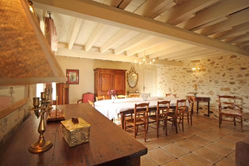 a kitchen and dining room with a table and chairs at Fonbanoux in Flavignac