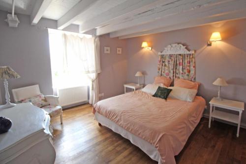 a bedroom with a large bed with a canopy at Fonbanoux in Flavignac