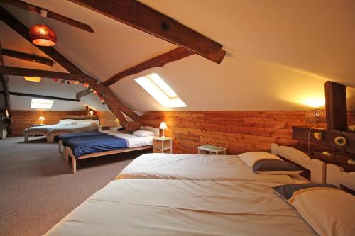 a bedroom with three beds in a room at Fonbanoux in Flavignac