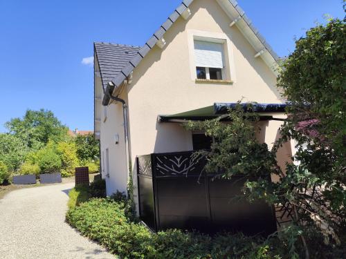 a house with a black gate in front of it at Chez Lily et Fred in Châlons-en-Champagne