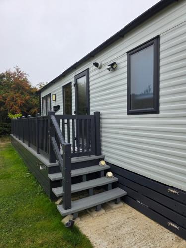 a staircase on the side of a mobile home at Hawthorn Lodge in Saint Helens