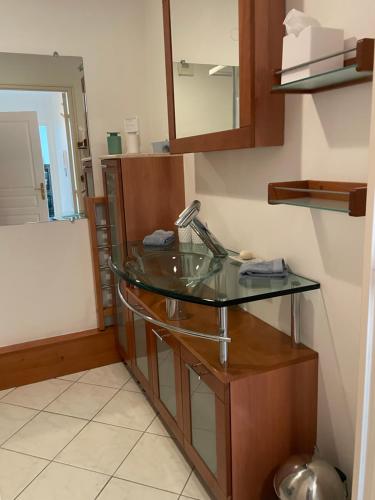 a bathroom with a glass sink and a mirror at Prince de Galles in Cannes