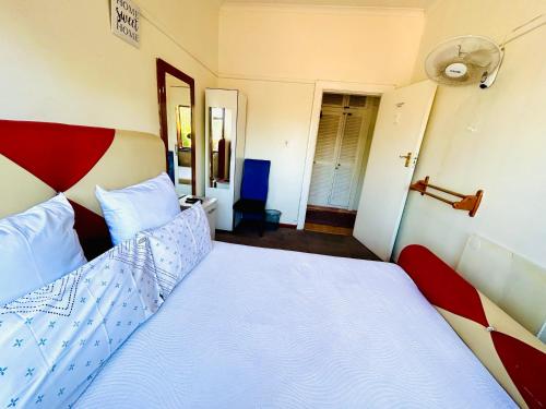 a bedroom with a large bed with a red headboard at Executive Accommodation Bellville 1 in Bellville