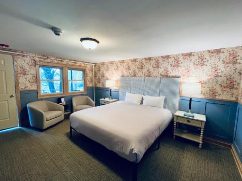 a bedroom with a large bed and a chair at Stonehurst Manor Breakfast & Dinner Included in North Conway