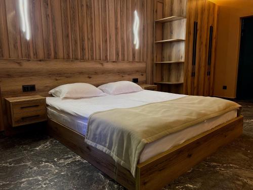 a bedroom with a large bed with white sheets and pillows at Solva Resort Medical & SPA in Polyana