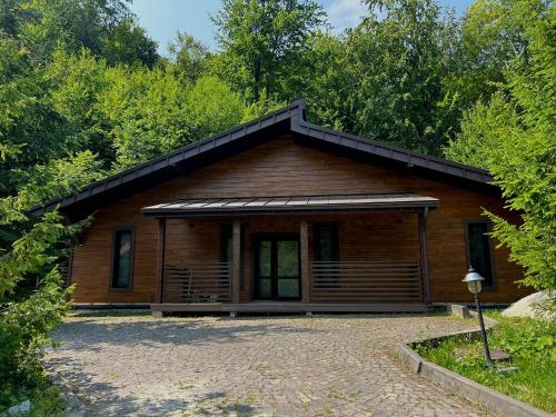 a log cabin with a gambrel roof at Solva Resort Medical & SPA in Polyana