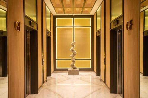 a hallway with a statue in the middle of a building at Tokyo River side PIK2 By Micky Studio 4 in Muara