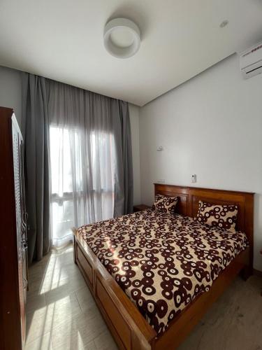 a bedroom with a large bed and a window at Keur Moussa in Dakar