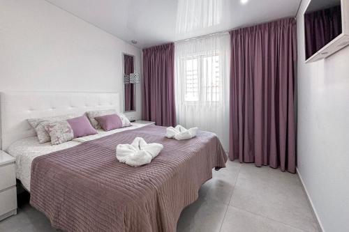 a bedroom with a bed with two towels on it at Fantastic vacation by the ocean in Playa de las Americas