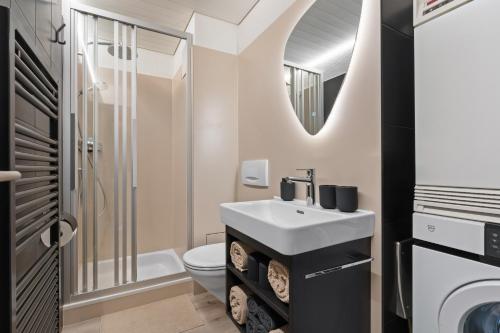 a bathroom with a sink and a toilet at Alpine Gem - AC - FreeParking - LakeBeach 8min drive in Altdorf