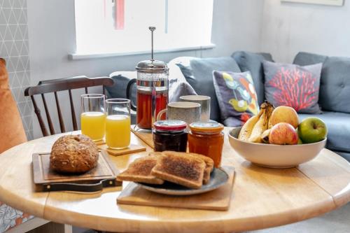 a table with a breakfast of toast and fruit and juice at 2 Bed in Lostwithiel oc-m32537 in Lostwithiel