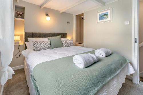 a bedroom with two beds with towels on it at 2 Bed in Lostwithiel oc-m32537 in Lostwithiel