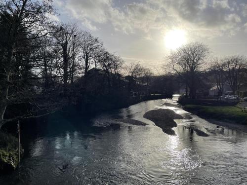 a river with the sun reflecting on the water at 2 Bed in Lostwithiel oc-m32537 in Lostwithiel