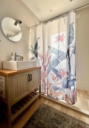 a bathroom with a sink and a shower curtain at NEW! Remote cosy apartment in Covas