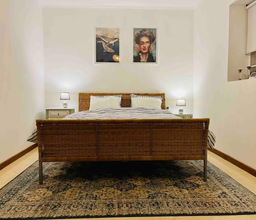 a bed in a bedroom with two pictures on the wall at NEW! Remote cosy apartment in Covas