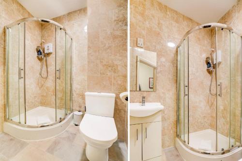 a bathroom with a toilet and a shower at Belvilla Ilford Hill Hotel London in Ilford