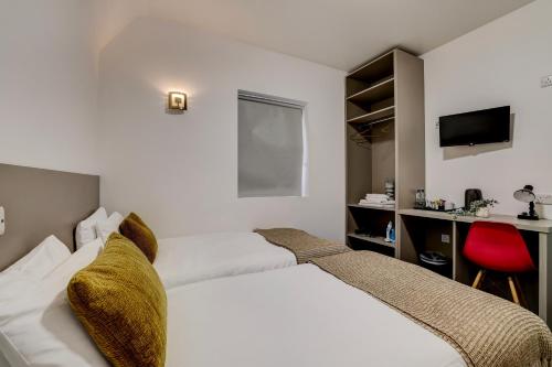 a bedroom with a white bed and a red chair at Belvilla Ilford Hill Hotel London in Ilford