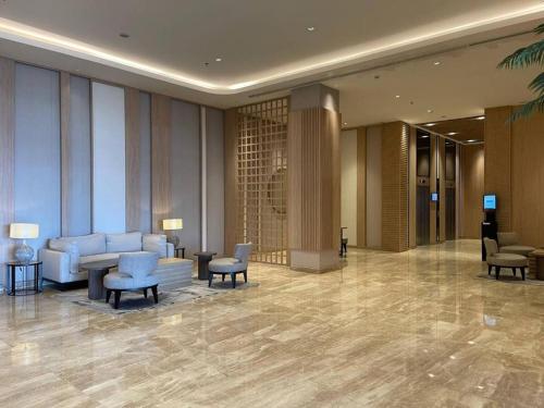 a lobby of a hotel with chairs and tables at Tokyo River side PIK2 By Micky Studio 5 in Muara